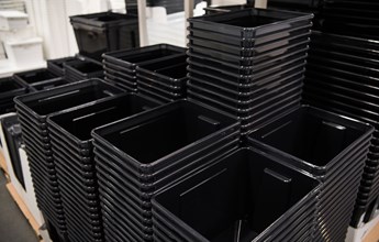 black-plastic-box-containers-in-row-at-store-2021-08-26-15-53-30-utc